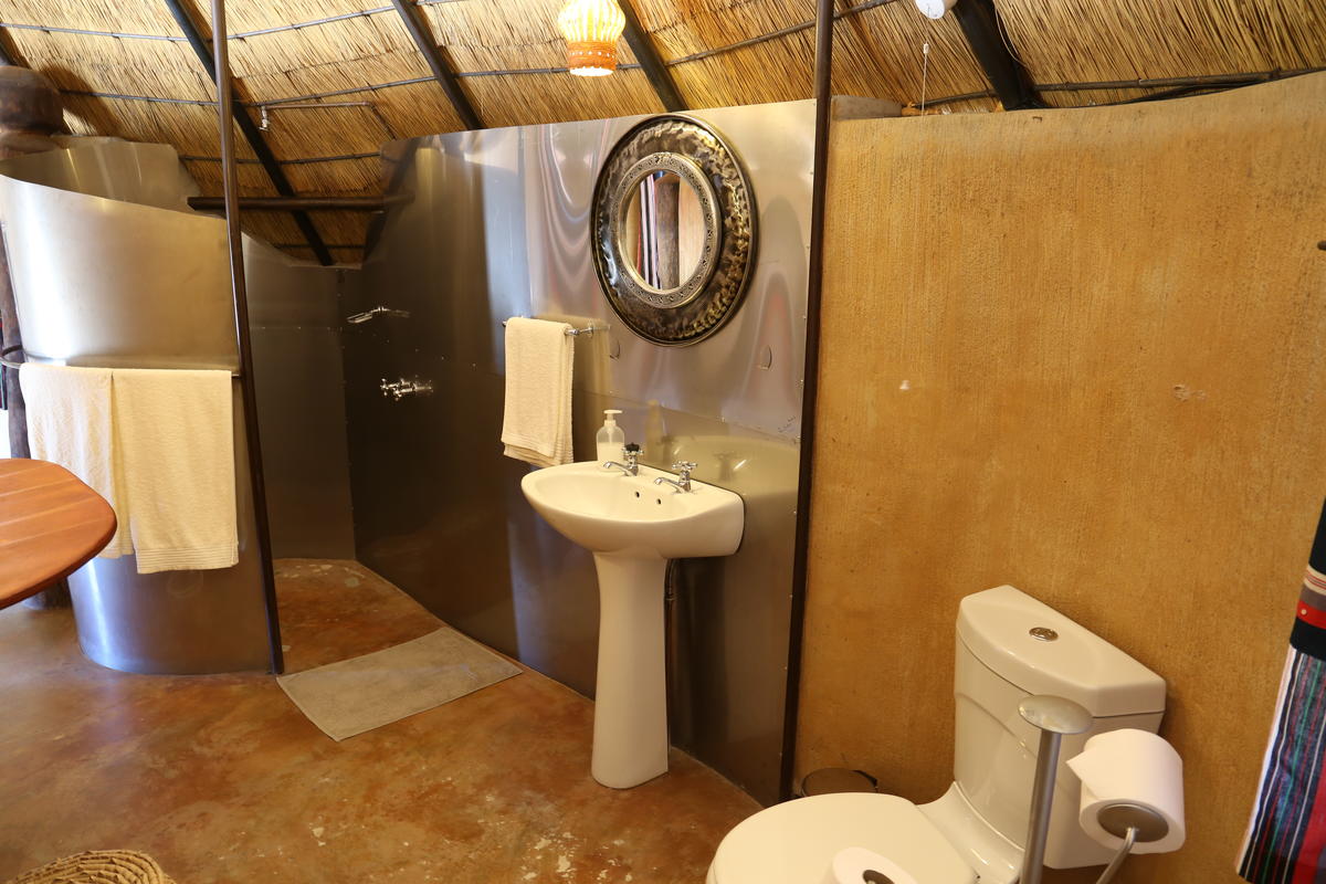 a bathroom with a toilet, sink and shower